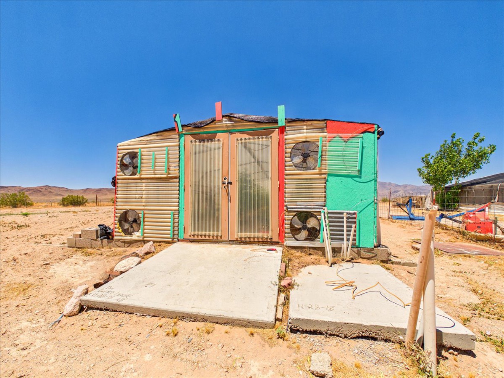 An evaporative-cooled greenhouse