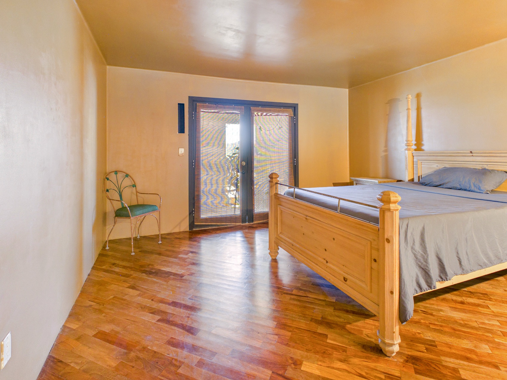 A bedroom with French doors to the desert