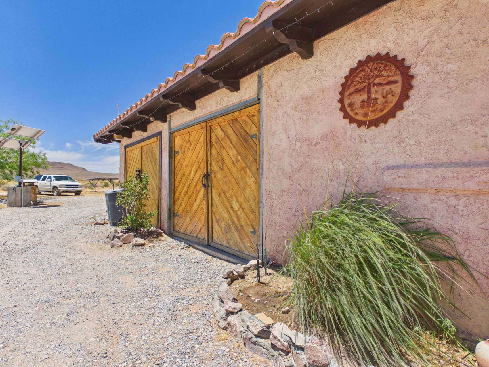 Handmade arched doors beneath the sun medallion