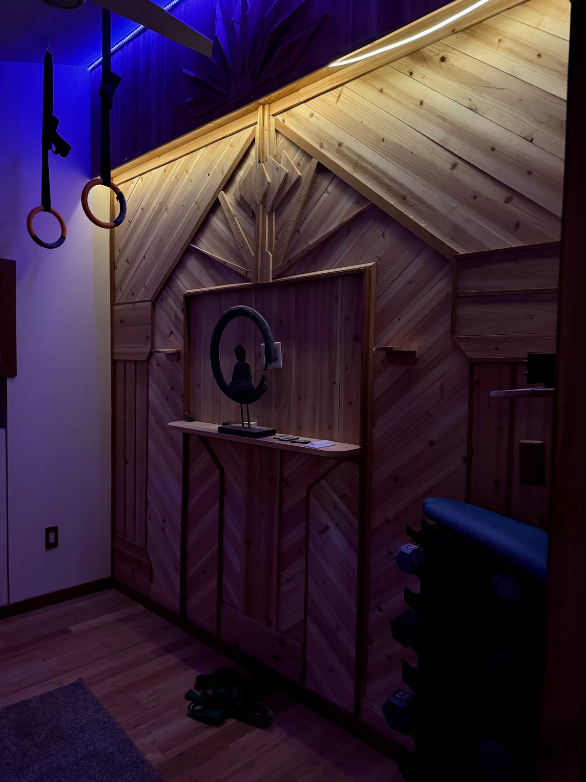 The radiant-heated yoga room and wood art wall